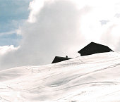 Huts outlined, high mountain in winter