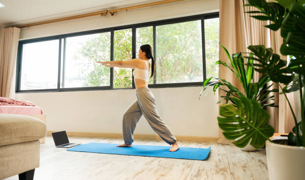 istock Asian girl exercising at home 1487717736