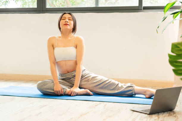 istock Asian girl exercising at home 1487717818