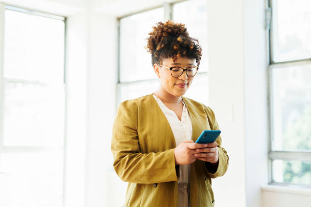 istock Businesswoman using cellphone in office 1487719498