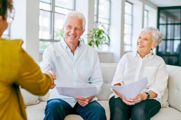 istock Senior couple shaking hands with financial advisor at home 1487719540