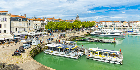 Passeur Yelo boats moored at a pier of the Old Port of La Rochelle, France