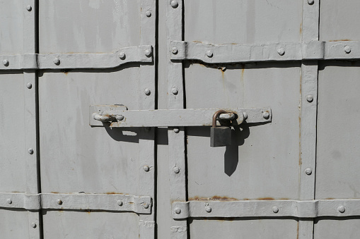 a close up of a metal door with a padlock