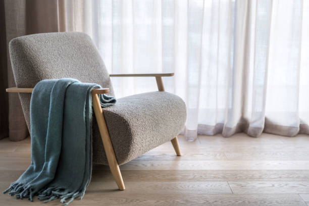 istock Plaid throw over wooden armrest on armchair 1487722374