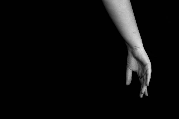istock black and white female hands with closed fingers on dark background with copyspace for your text 1487727076