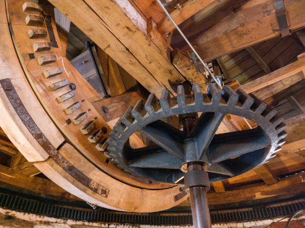 Gear rims in the gears in the cupola of an old wind mill stock photo