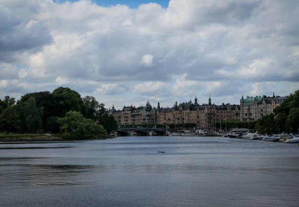 istock Scenic view of river by buildings against sky 1487730429