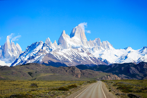 Road that leads to El Chalten, with the mountains of Fitz Roy on the background, Patagonia Argentina.