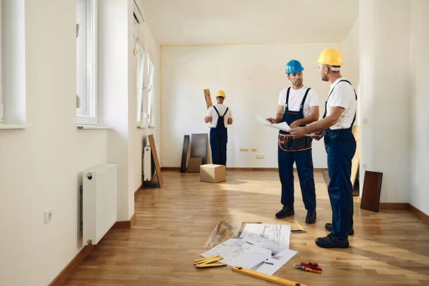 istock Male carpenters talking while analyzing housing project in apartment. 1487730688