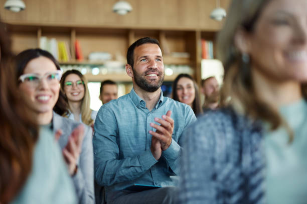 istock Happy entrepreneurs applauding on a seminar in board room. 1487733164