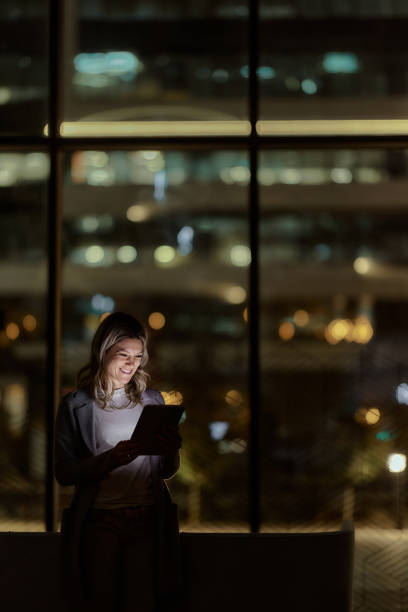 istock Happy businesswoman using touchpad late in the office. 1487735884