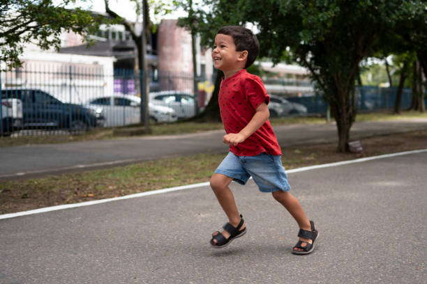 Smiling child running in public park