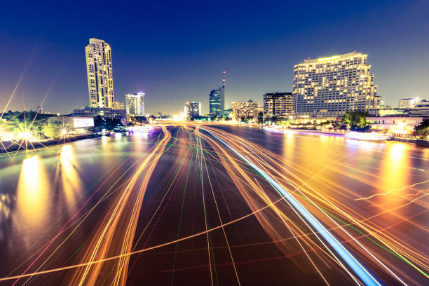 Boats moving on Chao Phraya river, Bangkok, Thailand. Very long exposure shot.
