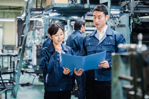 Workers checking production plans at the factory