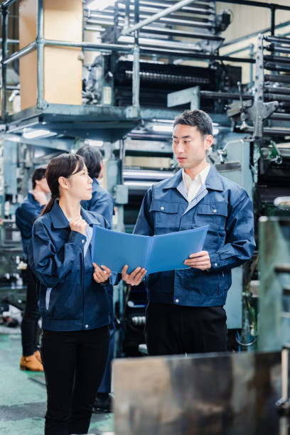 istock Workers checking production plans at the factory 1487739960