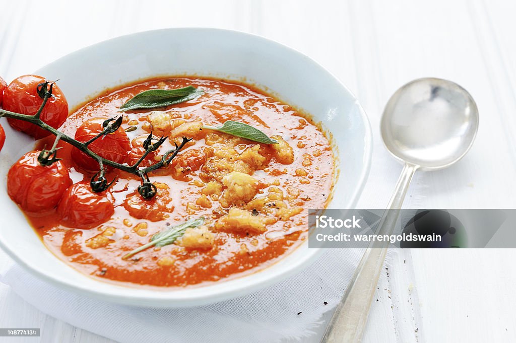 Home made tomato soup Bowl of fresh delicious tomato soup with croutons and sage garnish on white rustic surface; healthy eating Bright Stock Photo