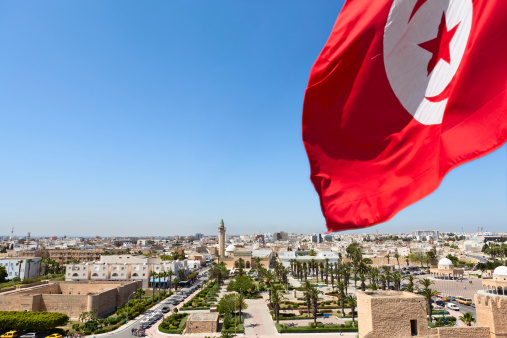 Top view of streets at Monastir city, Tunisia Minaret of mosque and Ribat as a fortress red Tunisian flag