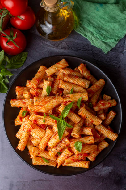 istock Penne pasta with tomato sauce 1487747410