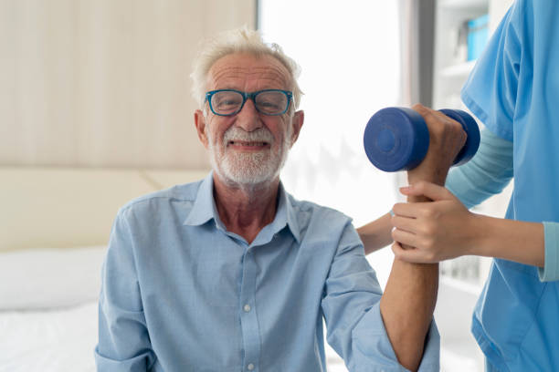 istock Physiotherapist man giving exercise with dumbbell treatment About Arm and Shoulder 1487748767