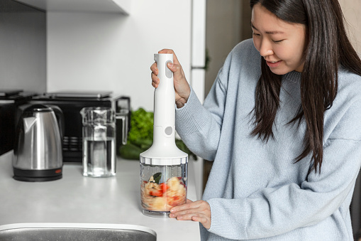 Asian woman making smoothie. Healthy life style.