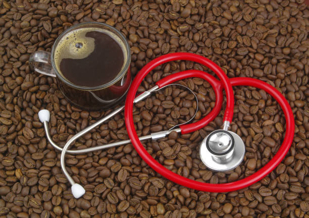 istock Cup of coffee with stethoscope on coffee beans. 1487761152