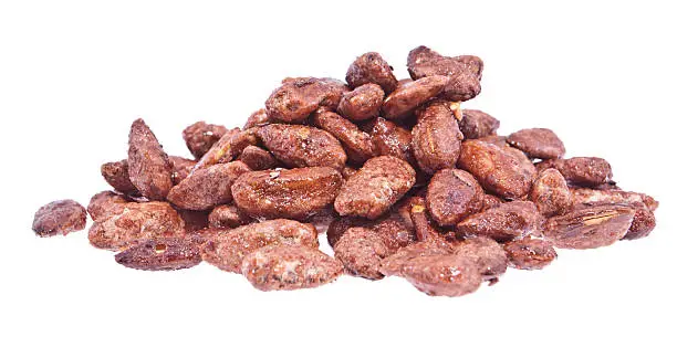 Heap of roasted almonds isolated on white background (with clipping path)