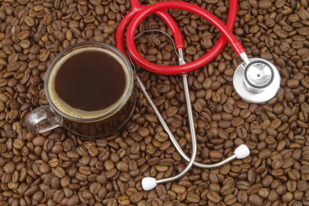 istock Cup of coffee with stethoscope on coffee beans. 1487762281