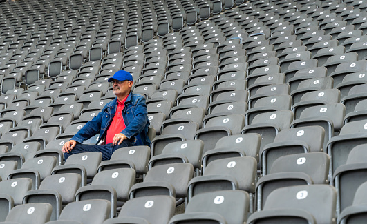 Low Angle View Of Man Sitting In Stadium
