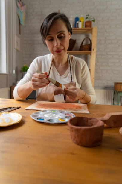 istock Woman painting a pottery 1487764255