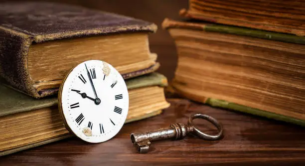 Photo of Vintage watch and key with books, escape room game banner
