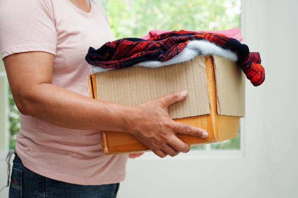 istock Clothes donations in cardboard box for volunteer. 1487767866