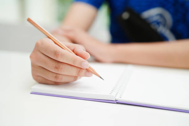 istock Asian teenage student write homework, study lesson for exam online learning education. 1487768259