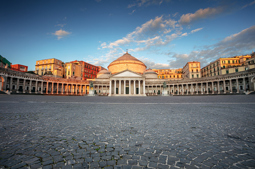 Cityscape image of Naples, Italy with the view of large public town square Piazza del Plebiscito at sunrise.