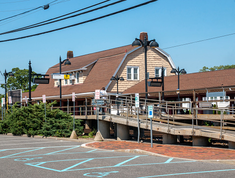 Bay Shore, NEw York, USA - 30 May 2022: The Bay Shore Long Island train station and parking lot used to bring passengers to the Fire Island Ferry.
