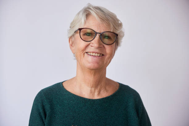istock Senior woman with glasses smiling on a light background 1487774693