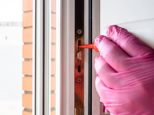 istock hand in glove lubricating window frame close up 1487775471