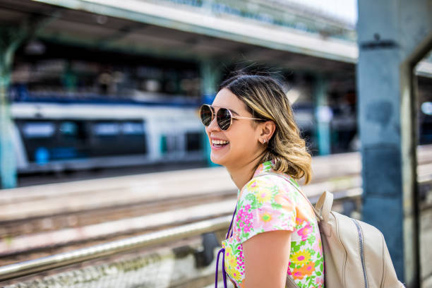 istock woman is looking at arriving train at a railway station 1487777190