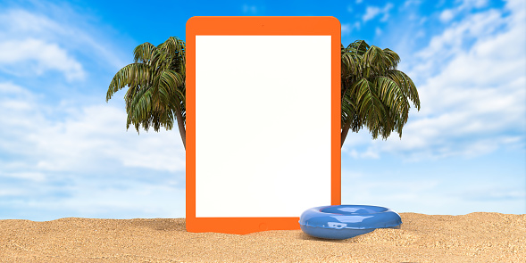 Summer holiday reservation and online shopping application. Empty white digital tablet screen standing on sandy beach, inflatable toy and palm trees. Beautiful sky background, copy space. Planning, searching, finding, buying travel ticket.