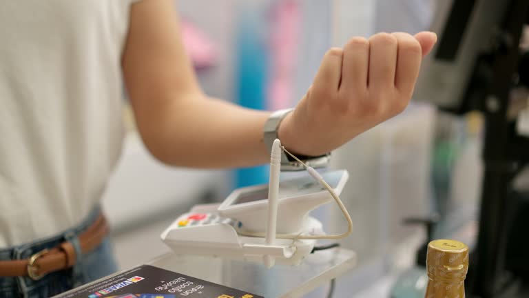 Woman using smartwatch to scan QR code for payment