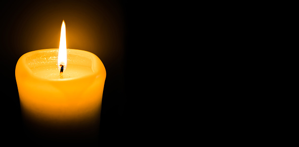 Banner. White candle burns on a black background. Place for the text, postcard. The concept of grief,sorrow, sadness saving light, copy space,mocap, religion,poster, template, postcard