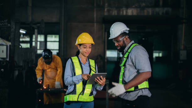 istock Engineer are working and discussing in the factory background is worker welds and cutting a metal. 1487793276