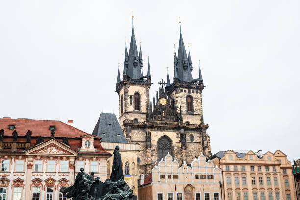 Low-angle view of the Church of Our Lady before Tyn in Prague against a cloudy sky.