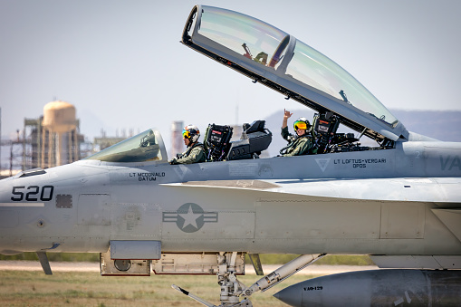 Tucson, Arizona, USA - March 25, 2023: Two Naval Aviators return after performing a demonstration of the EA-18G Growler at the 2023 Thunder and Lightning Over Arizona airshow.