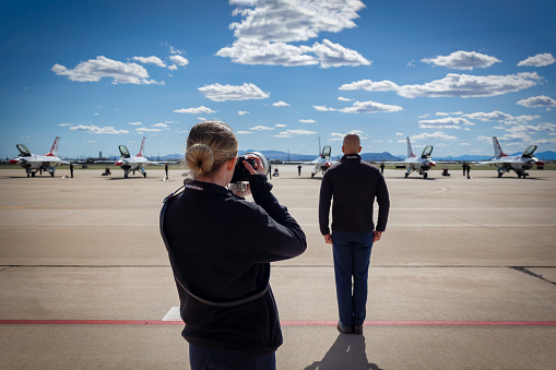 Tucson, Arizona, USA - March 24, 2023: A photographer with the US Air Force Thunderbirds shoot the team at the 2023 Thunder and Lightning Over Arizona airshow.