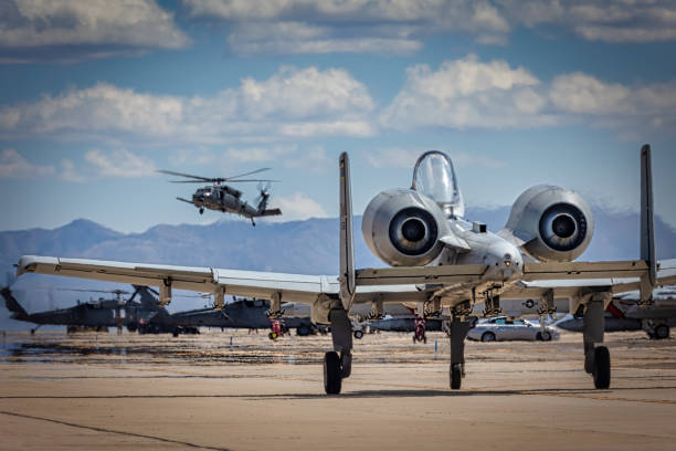 Tucson, Arizona, USA - March 24, 2023: An A-10 Thunderbolt II taxis while a CH-53 Sea Stallion lands in the background at the 2023 Thunder and Lightning Over Arizona airshow.