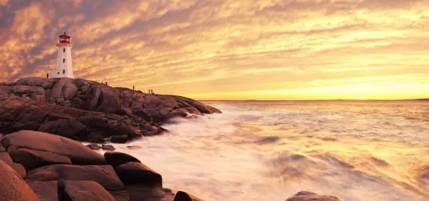 A brilliant sunset at Peggy's Cove Lighthouse.  Panoramic long exposure.