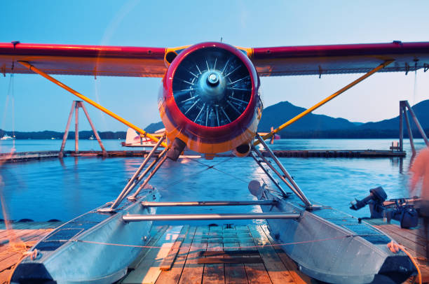 Seaplane Cooldown A seaplane throttles down for the evening.  Long exposure in twilight. bush plane stock pictures, royalty-free photos & images