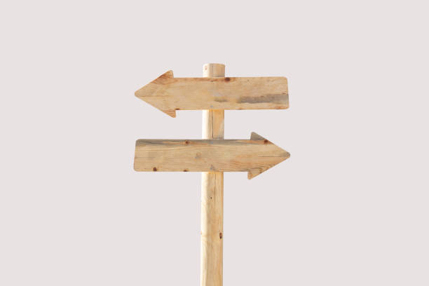 Blank wooden arrow road sign isolated on grey background. Wood signpost with copy space for text.