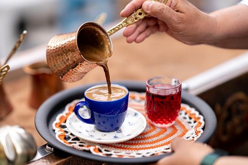 Brewing Turkish coffee on hot sand. The traditional method of making coffee in Turkey and the Middle East