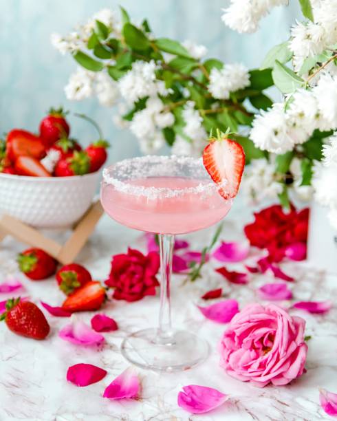 istock Glass with juice surrounded by flowers and strawberries 1487805351